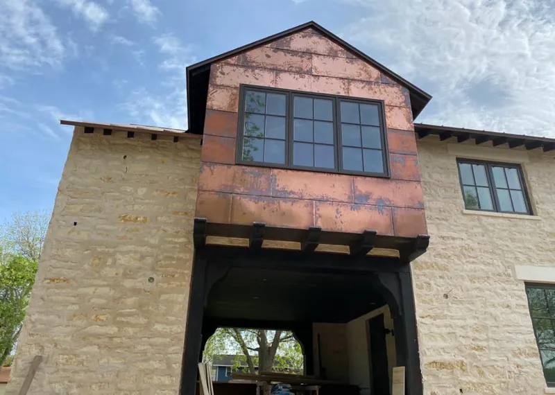 Copper metal panel facade on a stone building for Skylight Installation in American Fork